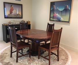 Round table with interior butterfly leaf, with 4 chairs.  Wall: left: "Bead Maker", rt.: "Crescent Moon", Lithographs, Signed & Numbered, R. C. Gorman, 1932-2005.