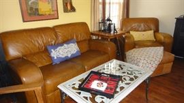 Leather loveseat, leather chair w/ Ottoman. Matching set. Glass and metal coffee table
