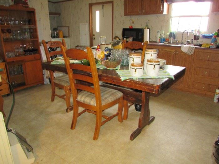 Farm style table. Chairs did not originally go with this table, but are the correct size. This could make a great set. Four chairs available. This would look great refinished or painted.
