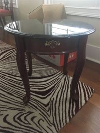 Side table, room size zebra print rug