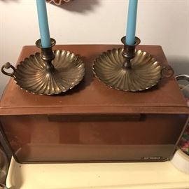 Vintage bread box and pair of brass candle sticks.