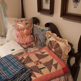 Antique 4 poster bed with quilts.