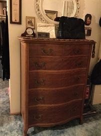 Serpentine front five drawer chest