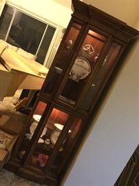 Tall narrow display cabinet lighted on two levels