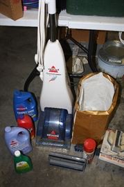 Bissell Carpet Cleaner with attachments and several bottles of cleaner