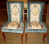pair of upholstered chairs with Asian design