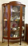 one of several antique curved glass china cabinet