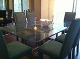 Beautiful glass top dining room table with upholstered 6 chairs.