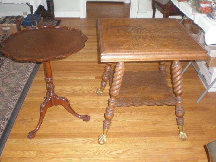 Round pie crust edge table and turned leg parlor table with glass ball and claw feet.