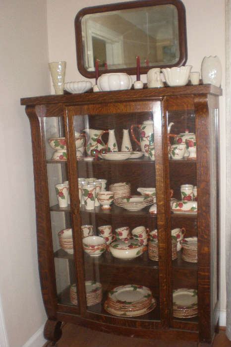 Beveled mirror, creamy white pottery, mission china cabinet, large set of Franciscan Apple dishes and accessories.