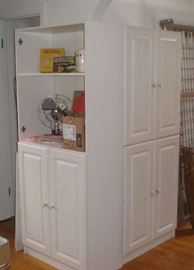Two tall white cupboards.