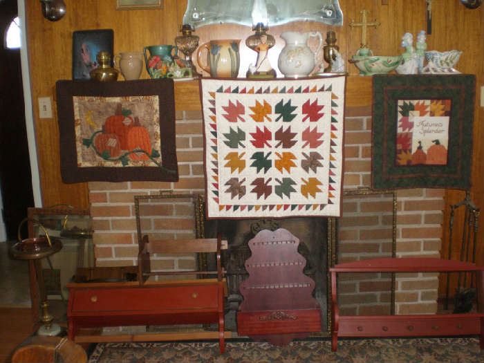 Quilted fall theme wall hangings, wall shelves, standing ashtray, praying hands plaque, crucifix, pitchers, oil lamps, knick-knacks, wall mirror.