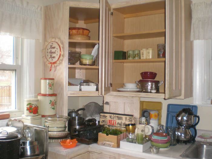Tin cannisters, pots, coffee maker, bowls, white Corelle, casserole, cups, bglasses and more.