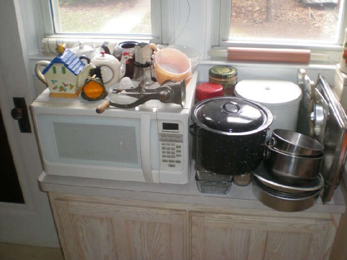 Microwave, teapots, fireking, canning pot, bowls, pie plates, cake pans, cookie sheets, large cannister.