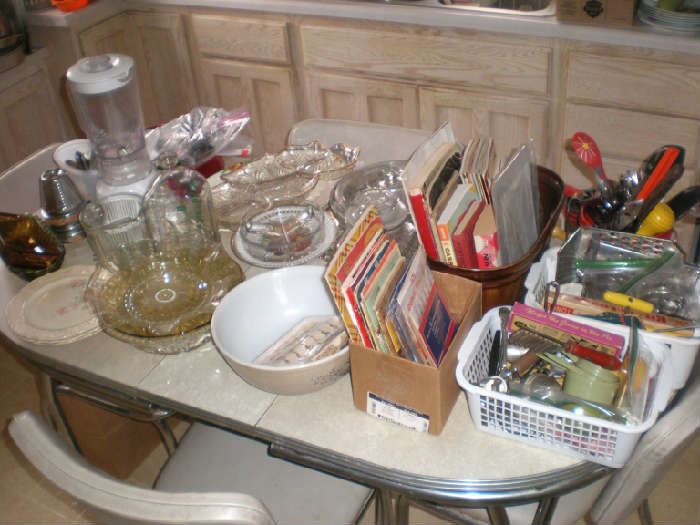 Blender, bowls, plates, cookbooks, kitchen tools.