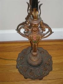 Ornate base on antique floor lamp.
