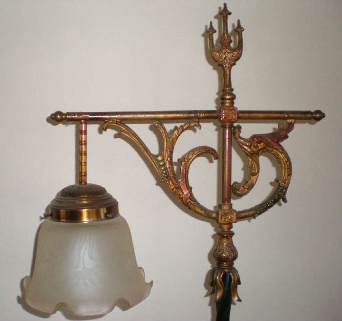 Ornate top on antique floor lamp.