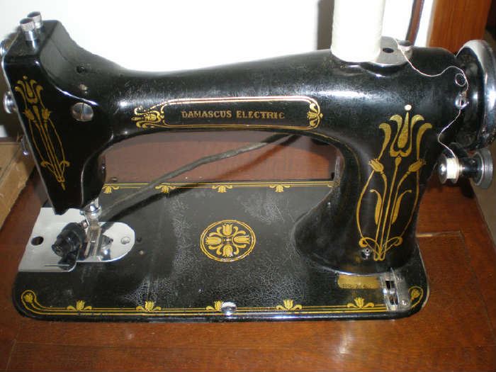 Close up of Damascus Electric sewing machine in cabinet.
