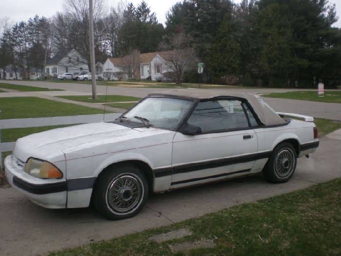 1988 Ford Mustang Convertible, white, red interior, 183,835 miles, runs good, needs new top.