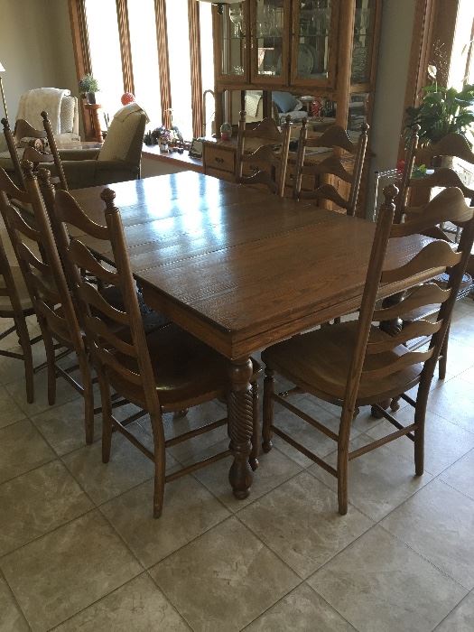Vintage dining room set with eight wooden ladder back chairs. Table has two leaves. 