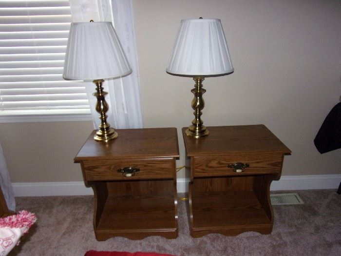 Two brass lamps and two oak end tables with drawer