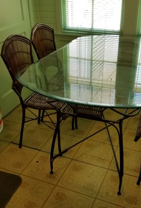 cute glass top and iron table and chairs with woven seats and backs