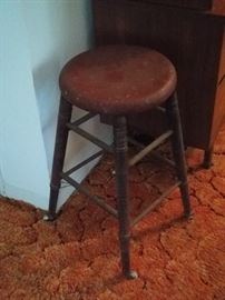 old farm stool with porcelain rollers