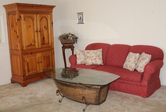 View of Family Room Showing Natural Pine Armoire, Klaussener Red Plaid Sofa (1 of 2 shown) and a very unique Glass Top Boat Coffee Table.  In the background is an Oriental Marble Top Plant Stand