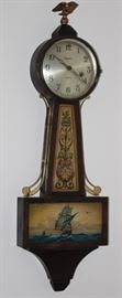 Antique Federal Style E Ingraham Mahogany 8 Day Time and Strike Banjo Clock with Eagle Finial.  This clock has a rectangular base featuring a hand painted image of a Yankee Clipper ship.  Yoke of Clock is decorated with scrolling and dragon motif flanked on either side with metal scroll work,