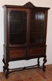 Antique Double Glass Door China Cabinet Raised on Scrolled Legs with Finial Center Cross Stretcher Base