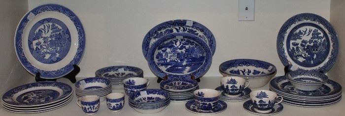A Collection Of Blue Willow:   Left:  Chop Plate,  Alfred Meakin Teapot (not shown), Alfred Meakin Berry Bowls.  Center:   Occupied Japan Platter and Bowl surrounded by various other Made in Japan Cups & Saucers, Berry Bowls and B & B Plates. Right: Churchill England Dinner Plates (7), Berry Bowls (2) and Round Vegetable Bowls (2)