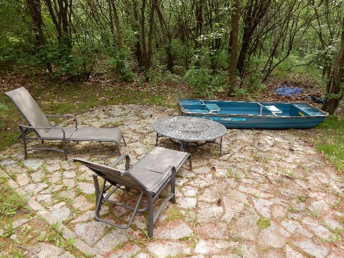 Coleman Rowboat 2 seater, Pair of Chaise Loungers and a Matching Firepit.  The boat has wood oars and anchor. 11 ft by 44 wide. 