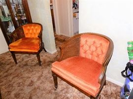 pair of tufted back cane side arm chairs.