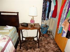Side table lamp and clothing in 1 bedroom