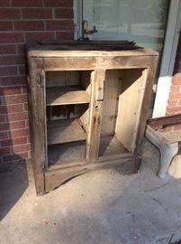 Primitive old ice box, in rough shape