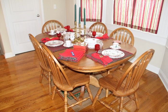 Oak dining table and chairs with Christmas dishes displayed