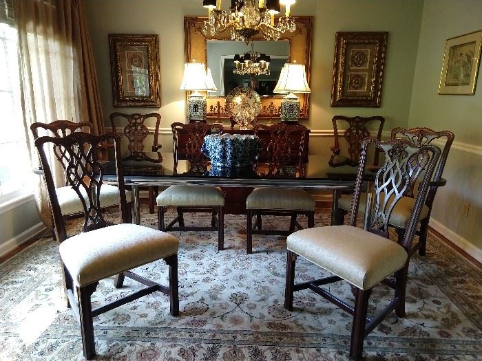 Dining room, with set of six hand carved mahogany Chippendale chairs (four side, two arm) plus an additional pair of armchairs. The rug is a Persian design Kashan, measuring 8' 6" x 11' 6", 1940's Drexel mahogany buffet, pair of blue & white Chinese porcelain lamps, with shades & finials, faux bamboo wall mirror, flanked by a pair of Home Good-ish doodad art things, Imari porcelain charger, St. Louis crystal vase.