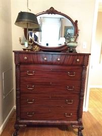 Beautiful vintage 6-drawer carved and ribbon mahogany chest. Even the secondary woods are ribbon mahogany; attached beveled glass mirror. Nice vintage French bouillotte table lamp.