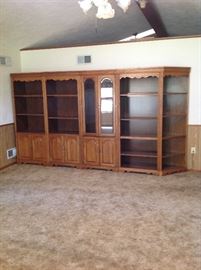 solid wood wall units 6-total other end unit in another room. This wall system lights & has glass beveled display unit w/glass shelves