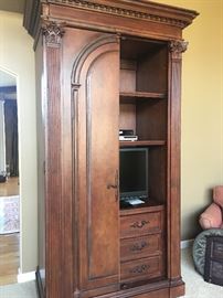 This stunning armoire provides plenty of storage plus the doors can be hidden completely in the side of the piece. 
