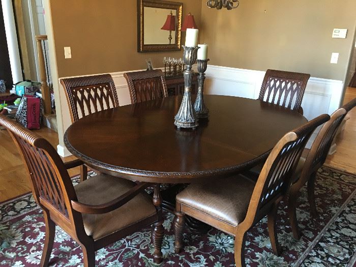 Bernhardt dining table in like new condition with 6 wood chairs with leather seats.