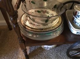 Miscellaneous plates, bowls, serving pieces on bottom shelf of tea cart