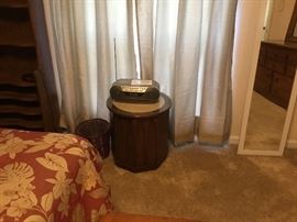Small table, radio, wastebasket