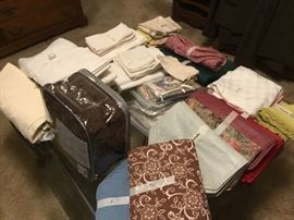 Various linens, glass top coffee table