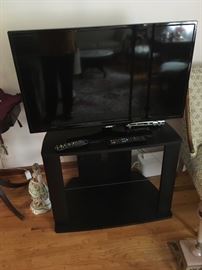 Large flat-screen TV with black stand