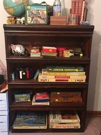 Beautiful Barrister Bookcase filled with vintage games, lunch boxes, globe collectibles