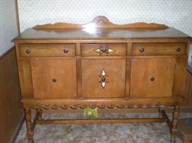 Buffet with (3) drawers and (3) doors for storage.  Also, there is a matching table with two leaves and (6) chairs. (see photo).   $275.00 for buffet, table (2) leaves,  (6) chairs and professionally made  table pads.