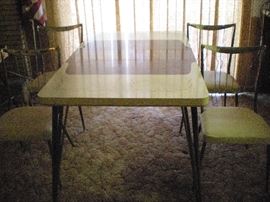 Kitchen table with leaf and (4) chairs.  $50.00 - Good condition.  58 1/2" L w/ leaf.  Leaf is 9 3/4" W. 