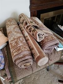 So many rugs -many new with tags never taken out of the plastic until now.