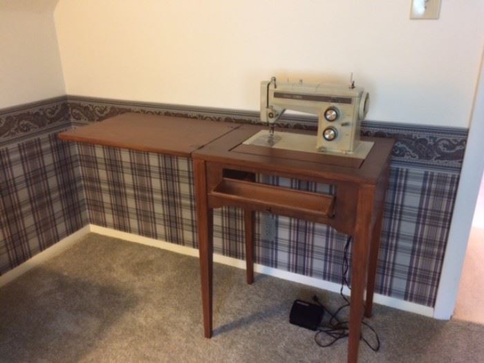 Kenmore sewing machine in stand...foot pedal and accessories.